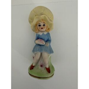 Vintage porcelain girl figurine with yellow bonnet and blue dress